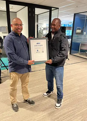 SafeCare Country Director Tanzania presenting the global certificate